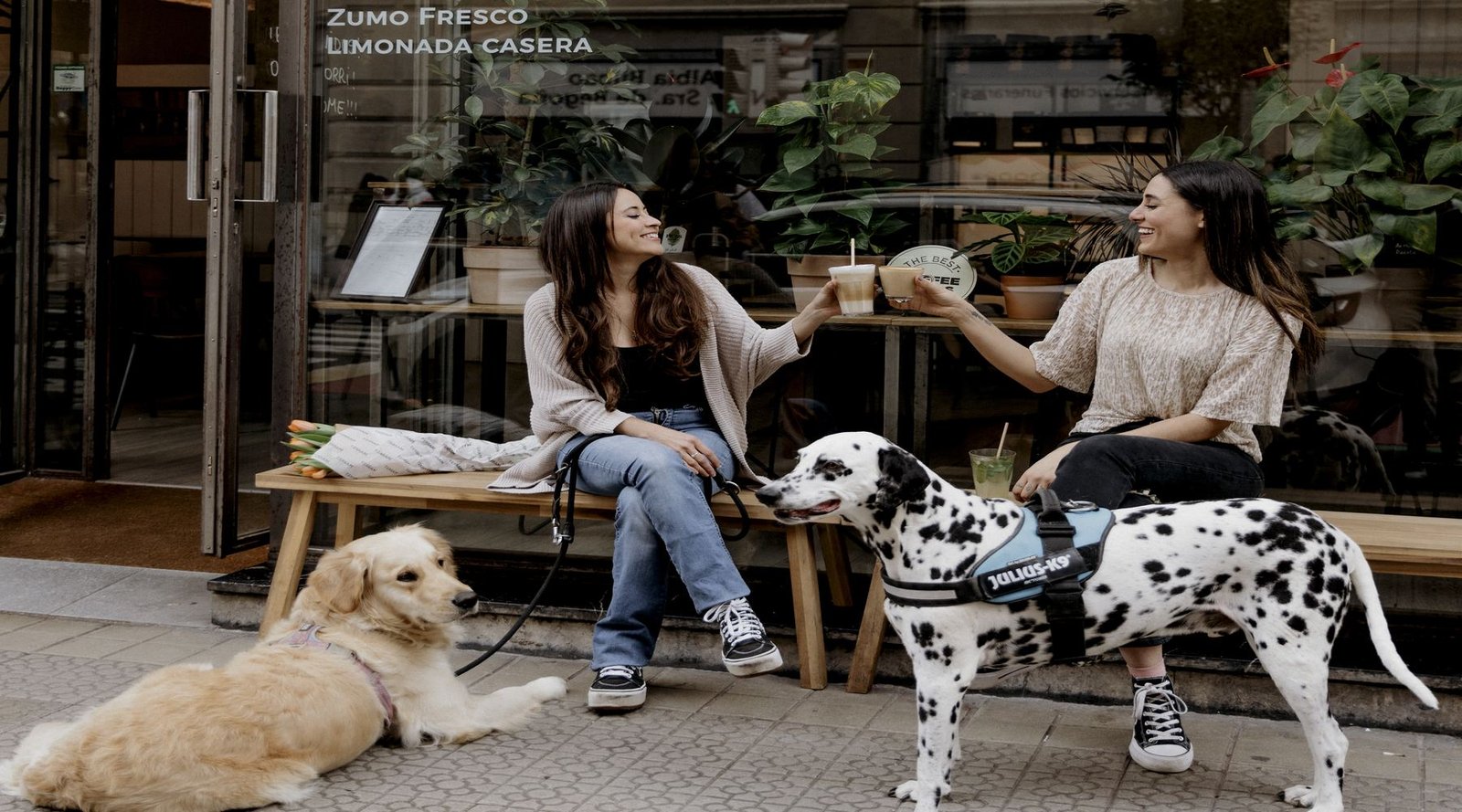 Two people and two dogs on the terrace outside ARVO Specialty Coffee Guggenheim in Bilbao